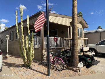 Charming home featuring desert landscaping, golf cart, and covered porch in a friendly community at 1277 S Shawnee Dr, Apache Junction, AZ 85119