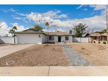 Charming single-story home with desert landscaping and a freshly painted exterior at 16810 N 65Th Pl, Scottsdale, AZ 85254