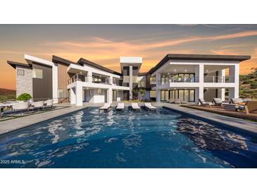 Expansive modern home with a large pool, spacious patio, and contemporary architectural style at 16856 N Mountain Pkwy, Fountain Hills, AZ 85268