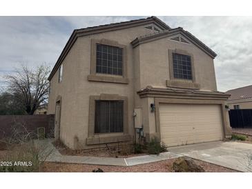 Two-story home with a two car garage, neutral stucco exterior, and tidy landscaping at 33287 N Windmill Run, San Tan Valley, AZ 85144