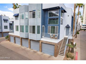 Contemporary townhome showcasing a private balcony, garages, and unique architectural details at 3633 N 3Rd Ave # 2016, Phoenix, AZ 85013