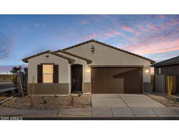 Charming single-story home with a two-car garage and low-maintenance desert landscaping at 36986 W Prado St, Maricopa, AZ 85138