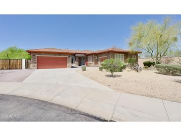 Charming single-story home featuring a well-manicured desert landscape, a spacious driveway, and a two-car garage at 4116 E Sierra Sunset Trl, Cave Creek, AZ 85331
