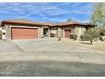 Beautiful single-story home with stone accents, a tile roof, a multi-car garage, and mature landscaping at 4116 E Sierra Sunset Trl, Cave Creek, AZ 85331