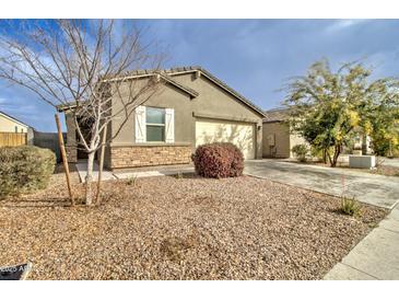 Charming single-story home showcasing desert landscaping and attached two-car garage at 4240 W Crossflower Ave, San Tan Valley, AZ 85144