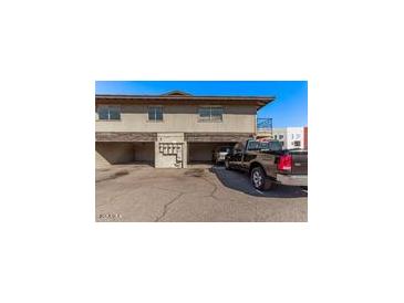 Apartment building with parking spaces and visible cars at 4714 E Belleview St, Phoenix, AZ 85008