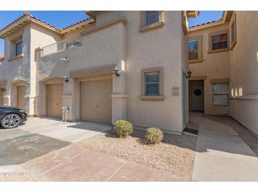 Charming townhome with a two-car garage and manicured desert landscaping at 525 N Miller Rd # 220, Scottsdale, AZ 85257