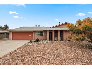 Charming single-story home with a desert-landscaped front yard and a two-car garage at 10453 W White Mountain Rd, Sun City, AZ 85351