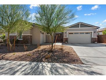 Charming single story home with stone accents, a two-car garage and desert landscaping at 12519 W Oyer Ln, Peoria, AZ 85383