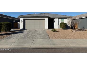 Charming single-story home with a neutral color palette, gray roof, and an attached two-car garage at 13342 W Lariat Ln, Peoria, AZ 85383