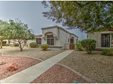 Charming single-story home featuring a well-maintained front yard and walkway at 16118 W Vista North Dr, Sun City West, AZ 85375