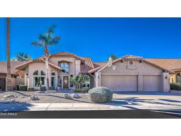 Inviting two-story home featuring desert landscaping and a three-car garage at 16402 N 48Th Way, Scottsdale, AZ 85254