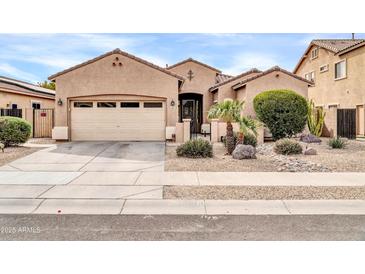 Charming single-story home with a two-car garage, desert landscaping, and a welcoming entrance at 16813 W Hammond St, Goodyear, AZ 85338