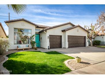 Charming single-story home with a well-manicured lawn, inviting curb appeal, and a two-car garage at 1737 E Marquette Dr, Gilbert, AZ 85234