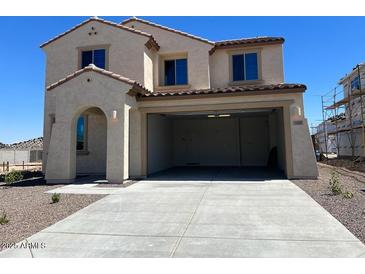 Stucco two-story home featuring an attached two-car garage and a well-manicured desert landscape at 19889 W Annika Dr, Litchfield Park, AZ 85340