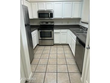 Bright kitchen with stainless steel appliances and white cabinetry at 20100 N 78Th Pl # 1007, Scottsdale, AZ 85255