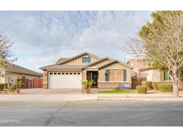 Charming single-story home with a well-manicured lawn, a two-car garage, and inviting curb appeal at 20742 E Mockingbird Dr, Queen Creek, AZ 85142