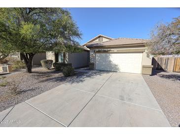 Charming single-story home with a well-maintained front yard and two car garage at 4514 W Ellis St, Laveen, AZ 85339