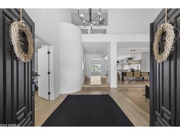 Bright foyer with an open floor plan, wood floors, and modern chandelier at 4602 E Oberlin Way, Cave Creek, AZ 85331