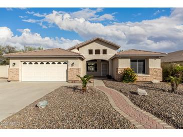 Charming single-story home with desert landscaping and a brick pathway to the entrance at 6060 W Charter Oak Rd, Glendale, AZ 85304