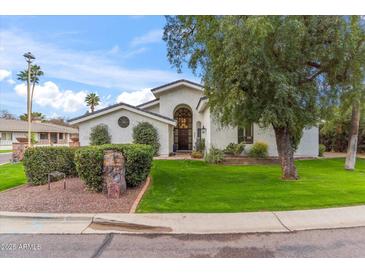 Charming single-Gathering home with a well-manicured lawn and beautiful desert landscaping at 6801 N 1St Pl, Phoenix, AZ 85012