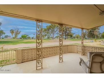 Spacious covered patio with open views of the adjacent green space, ideal for outdoor entertaining at 9402 N 109Th Dr, Sun City, AZ 85351