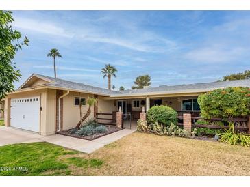 Charming single-story home with desert landscaping and a two-car garage at 9402 N 109Th Dr, Sun City, AZ 85351