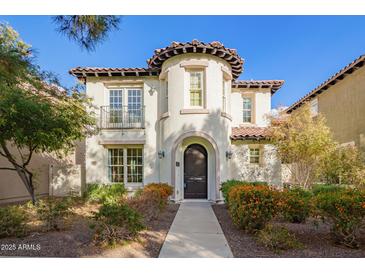 Charming two-story home with a stucco facade, a barrel tile roof, and manicured landscaping at 958 S Henry Ln, Gilbert, AZ 85296