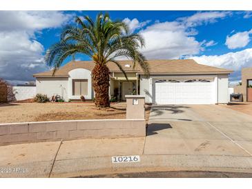 Charming single-story home featuring desert landscaping and a two-car garage at 10216 W Minnezona Ave, Phoenix, AZ 85037