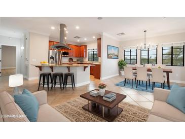 Open-concept living room with kitchen, dining area, and comfortable seating, perfect for modern living at 10757 N 74Th St # 2003, Scottsdale, AZ 85260