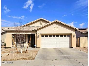 Charming single-story home featuring a well-maintained lawn, neutral-toned exterior, and a two-car garage at 12360 W Sherman St, Avondale, AZ 85323