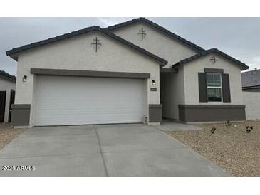 Charming single-story home with a two-car garage and desert landscaping at 1531 S 239Th Dr, Buckeye, AZ 85326