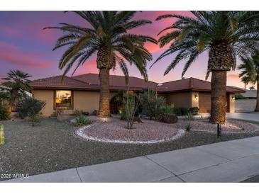 Charming single-story home with desert landscaping and elegant curb appeal at sunset at 20639 N 123Rd Dr, Sun City West, AZ 85375