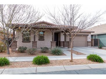 Charming single-story home featuring a well-manicured front yard and a two-car garage at 22465 E Via Del Verde --, Queen Creek, AZ 85142