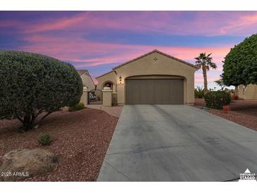 Single-story home featuring desert landscaping and a wide driveway leading to a two-car garage at 22524 N San Ramon Dr, Sun City West, AZ 85375