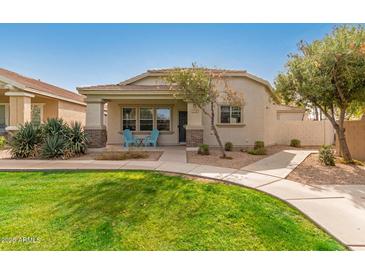 Inviting single-story home with well-manicured lawn, walkway, and covered porch at 4226 E Spawn Ln, Gilbert, AZ 85296