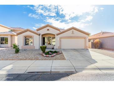 Charming single-story home featuring a two-car garage and well-maintained desert landscaping at 6009 W Questa Dr, Glendale, AZ 85310