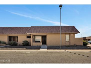 Cozy single-story home featuring desert landscaping, a tile roof, and the house number displayed above the front window at 601 W Yukon Dr # 1, Phoenix, AZ 85027