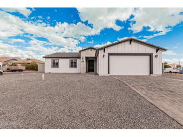 Charming single-story home featuring white siding, a gray roof, and a paved driveway at 6223 S Eagle Pass Rd, Gold Canyon, AZ 85118