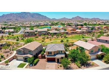 Expansive aerial view of a residential community with lush landscaping and mountain backdrop at 7337 S Debra Dr, Gilbert, AZ 85298