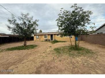 Expansive backyard with mature trees providing shade, perfect for outdoor activities at 8610 N 37Th Ave, Phoenix, AZ 85051