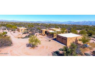 Tan home exterior with desert landscaping and a large lot and mountain views at 14925 E Morning Vista Ln, Scottsdale, AZ 85262