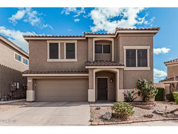 Charming two-story home featuring a two car garage and a well maintained front yard at 1735 W Wildwood Dr, Phoenix, AZ 85045