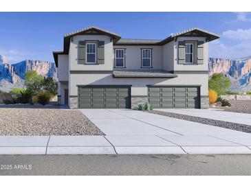 Two story home boasts a three car garage and desert landscaping at 21074 N 58Th St, Phoenix, AZ 85054