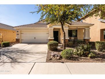 Charming single-story home with a well-manicured front yard and a two-car garage at 4189 E Sandy Way, Gilbert, AZ 85297