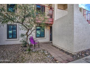 Inviting front entrance with desert landscaping, tile walkway, and second story balcony with wrought iron railing at 455 S Delaware Dr # 171, Apache Junction, AZ 85120