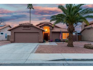 Charming single-story home with a well-manicured yard and beautiful desert landscaping at 474 W Smoke Tree Rd, Gilbert, AZ 85233