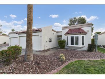 Charming single-story home featuring a red tile roof, well-maintained landscaping, and an attached two-car garage at 617 S Palo Verde Way, Mesa, AZ 85208