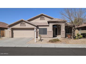 Charming single-story home featuring a well-maintained front yard and attached two-car garage at 8014 W Beaubien Dr, Peoria, AZ 85382