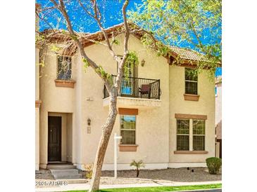 Charming two-story home featuring a private balcony, neutral stucco, and well-maintained landscaping at 1422 S Colt Dr, Gilbert, AZ 85296